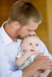 father kissing baby